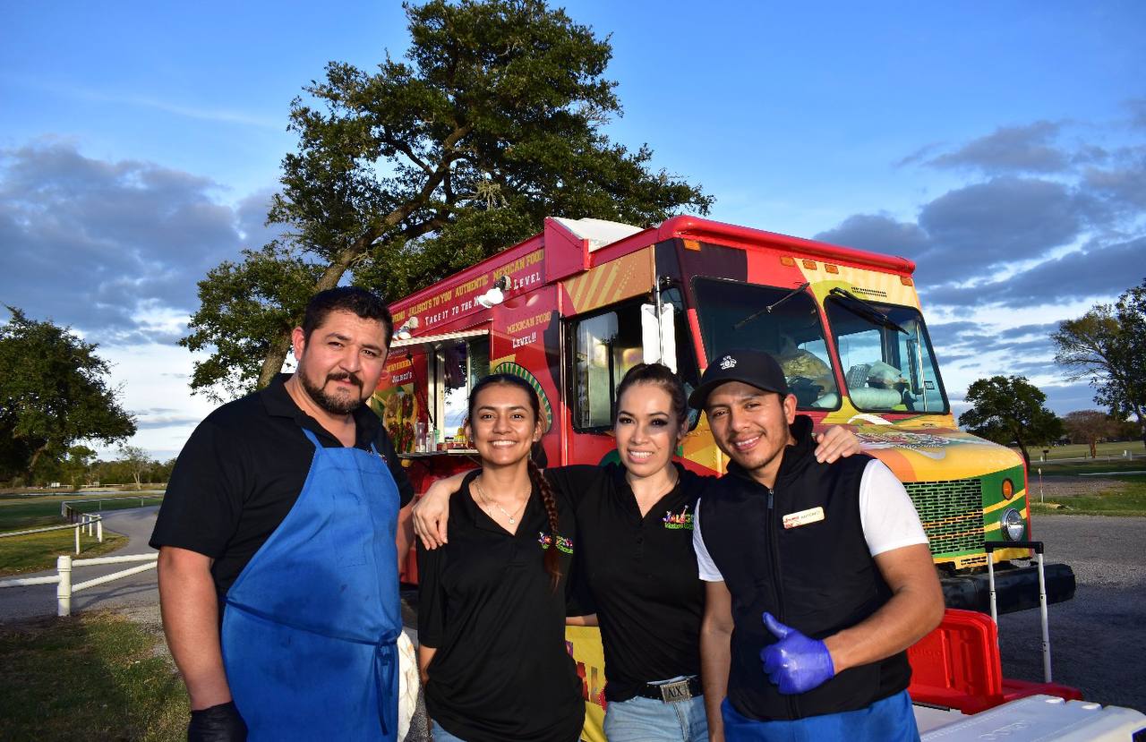 The full Jalisco Food Truck team proudly standing in front of the truck